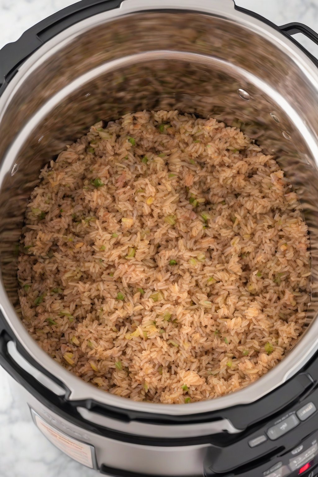 A high-resolution photo of Instant Pot dirty rice, fluffy and aromatic, in the pot with lid off, under soft lighting.